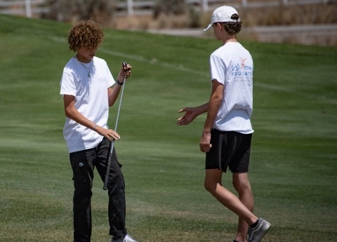 Two boys golfing