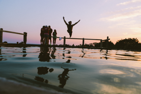 friends swimming jumping off pier
