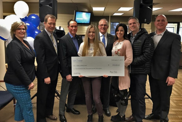 Group photo showing Aleah with check to Make-A-Wish Utah from We Promise Foundation