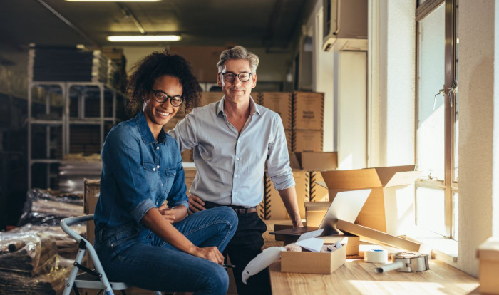 A man and a woman surrounded by their online business inventory