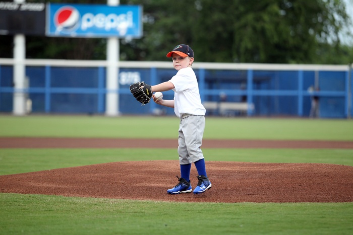 Little boy throwing first pitch