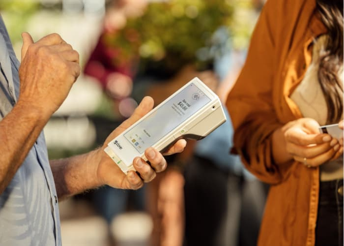 a man holding the Clover Flex Point-of-Sale product