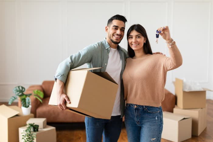 Happy couple showing keys of their new home