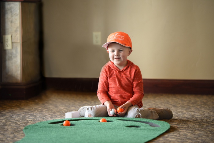 Little boy playing golf