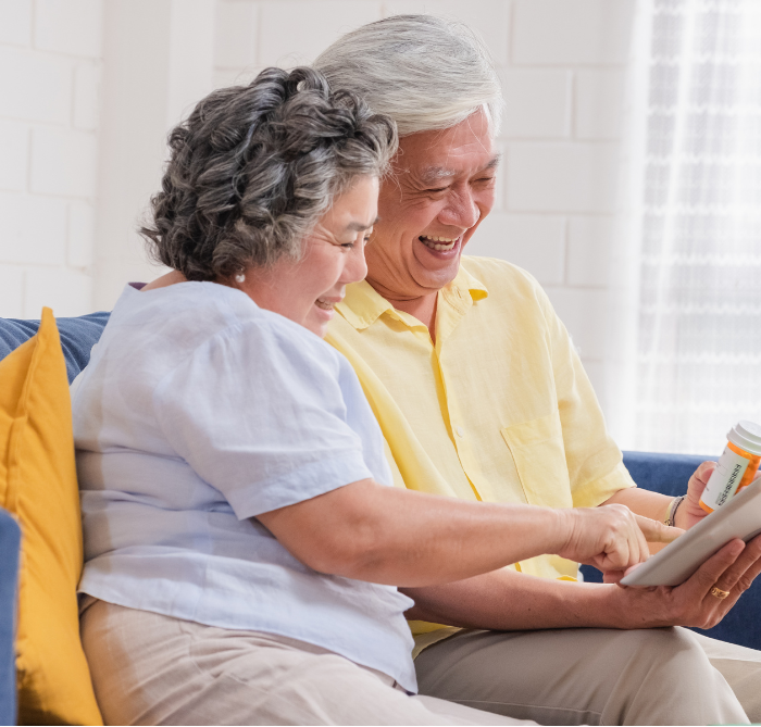 Elderly Asian couple looking at a tablet and seeking medical advice