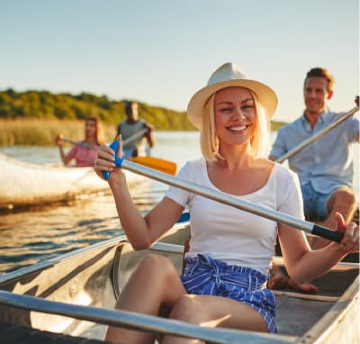 A couple paddling in a canoe on a river