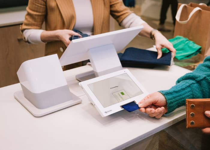 a customer using a Clover Station Duo to make a purchase