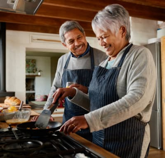 An elderly couple preparing a meal together