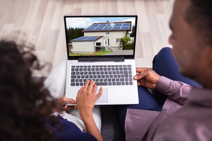 a couple looking at houses for sale online