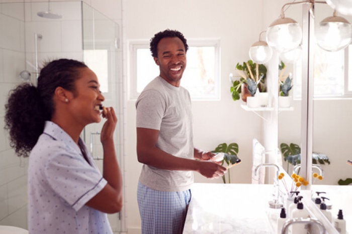 a happy couple smiling in their bathroom