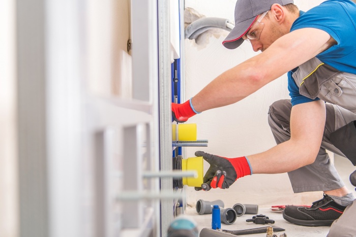 a plumber working on a bathroom remodel