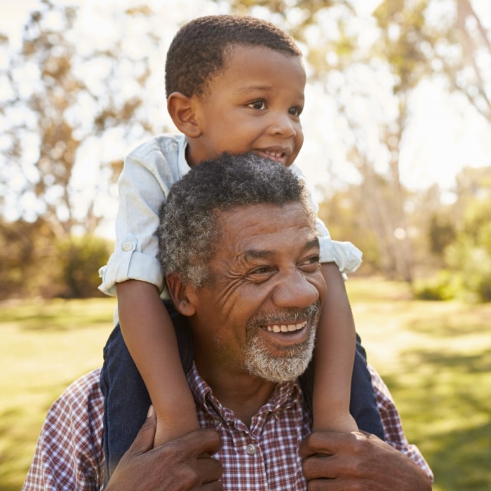 grandfather giving grandson a ride on his shoulders