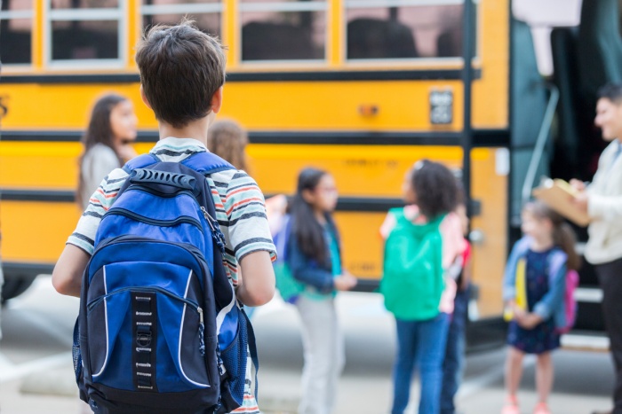 Kids getting on school bus