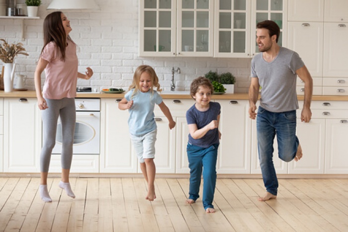 a happy family dancing in their newly remodeled kitchen