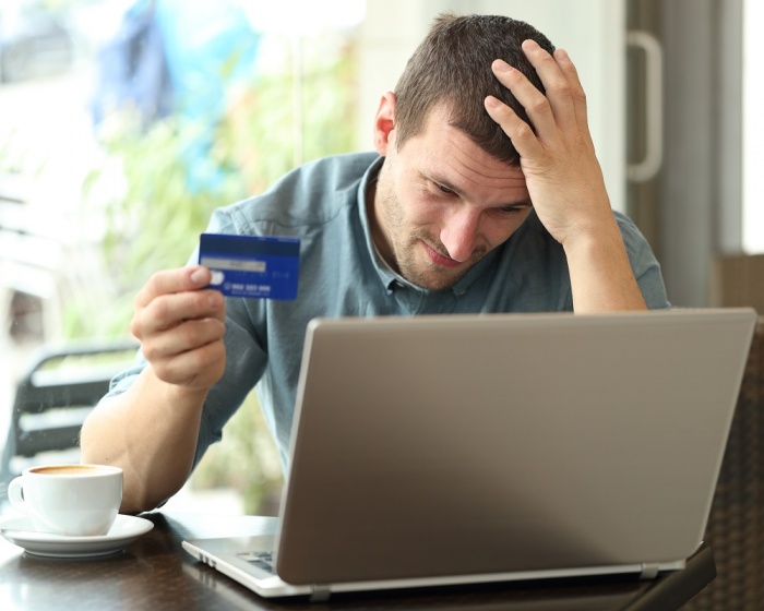 man worried over maxed out credit card