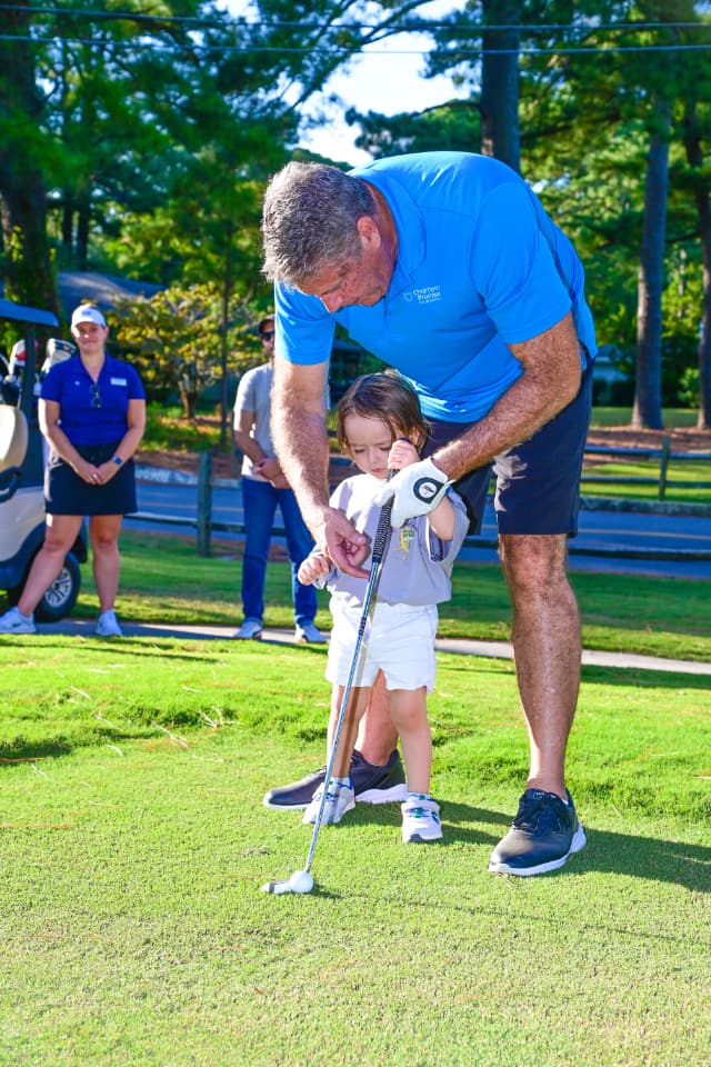 Donald Davis shows Max how to putt