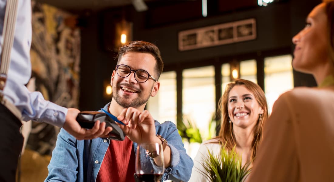 A man paying for a meal with his credit card
