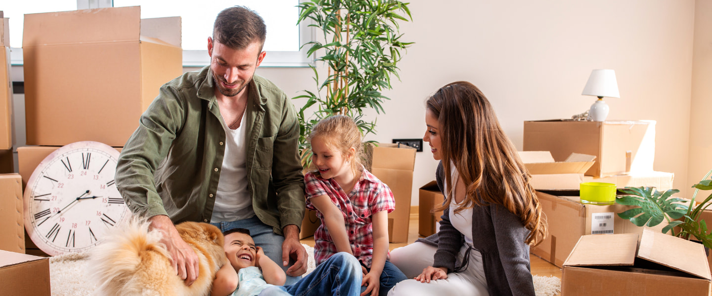 Family in their new home unpacking and playing