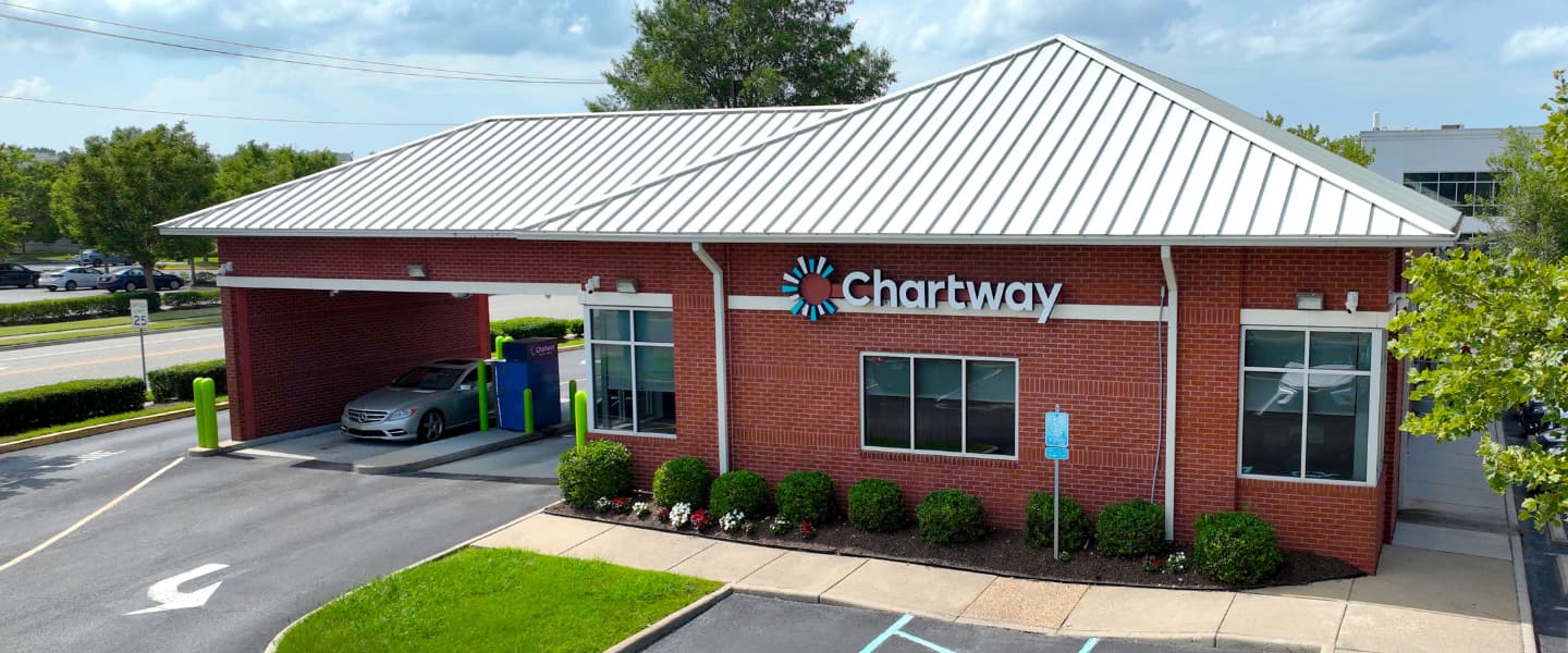 a red brick building with an entrance on the side for drive thru banking