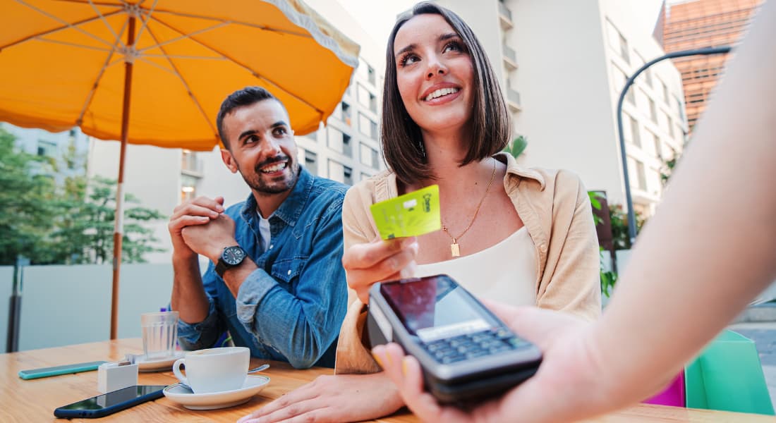 Woman paying for meal with Chartway Ignite Credit Card