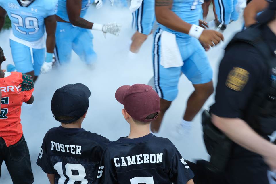 Cameron and Foster high fives at ODU and Virginia Tech game